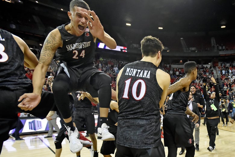 LAS VEGAS, NV - MARCH 10: Nolan Narain #24 of the San Diego State Aztecs celebrates with teammates after the team defeated the New Mexico Lobos in the championship game of the Mountain West Conference basketball tournament at the Thomas & Mack Center on March 10, 2018 in Las Vegas, Nevada. San Diego State won 82-75. (Photo by David Becker/Getty Images)